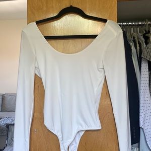 White long sleeve bodysuit with a low cut back. Size Small, from a boutique.